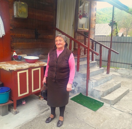 Maria Coroiu in front of her house